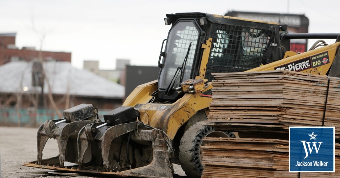 Construction equipment excavators with Jackson Walker logo