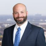 Travis McNellie with Jackson Walker logo