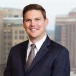 Christian Triantaphyllis with Jackson Walker logo