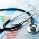 medical statistics and graphic charts with stethoscope