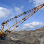 Crane in coal mine operation with Jackson Walker logo