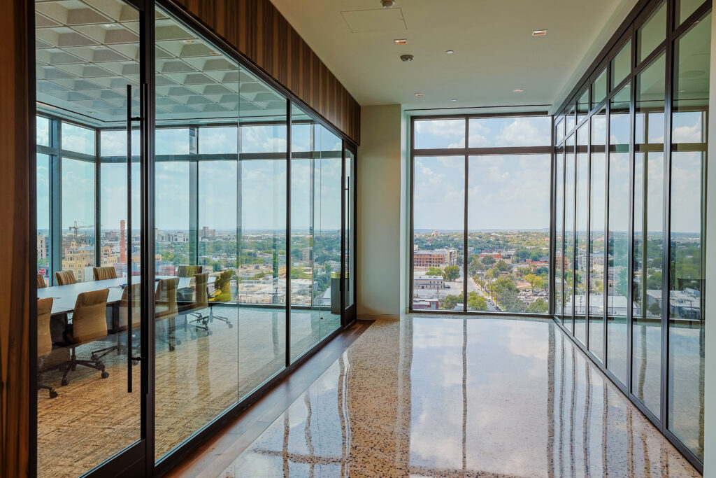 The office is an efficient and modern environment featuring floor-to-ceiling windows, collaborative spaces, and dedicated workspace for all employees.