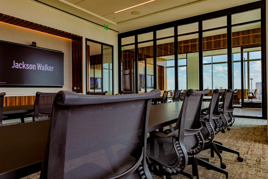 The space includes advanced video conferencing capability and interactive displays.